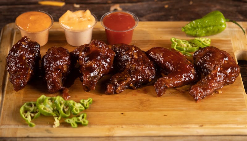 Wings over menu spread with multiple sauces and sides